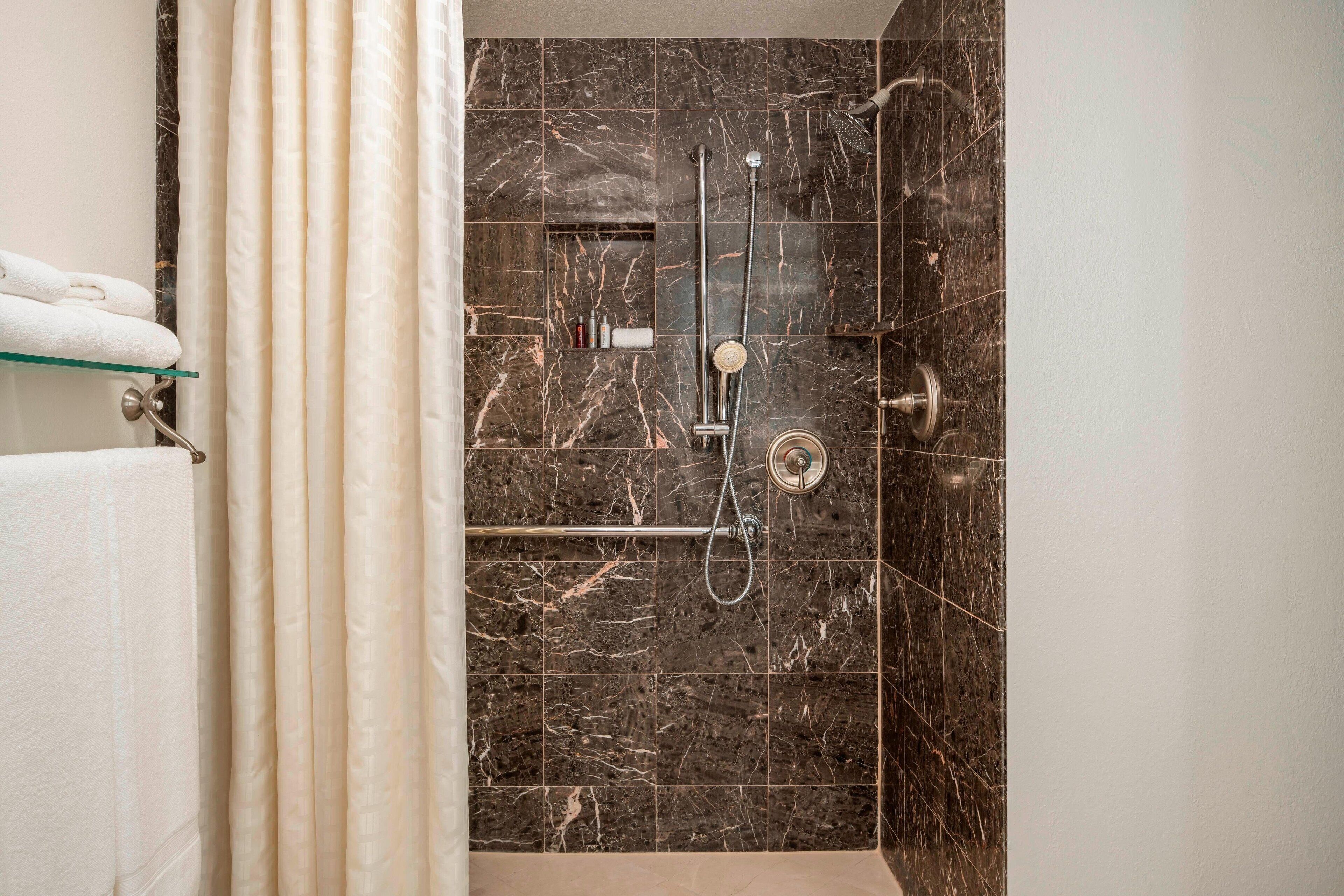 designer toiletries, hair dryer, towels