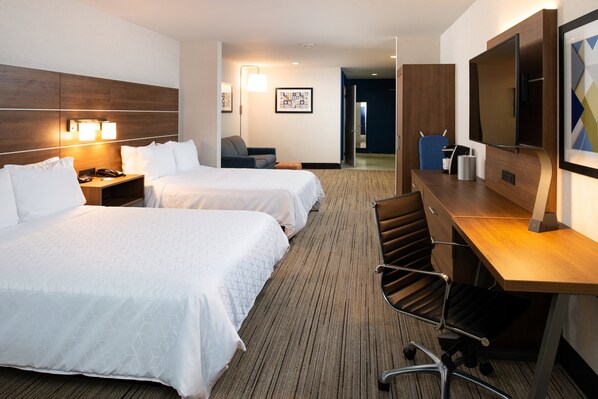 A hotel room with two beds, a desk, a chair, a TV, and a lamp. - Holiday Inn Express & Suites Los Angeles Downtown West by IHG (Los Angeles)