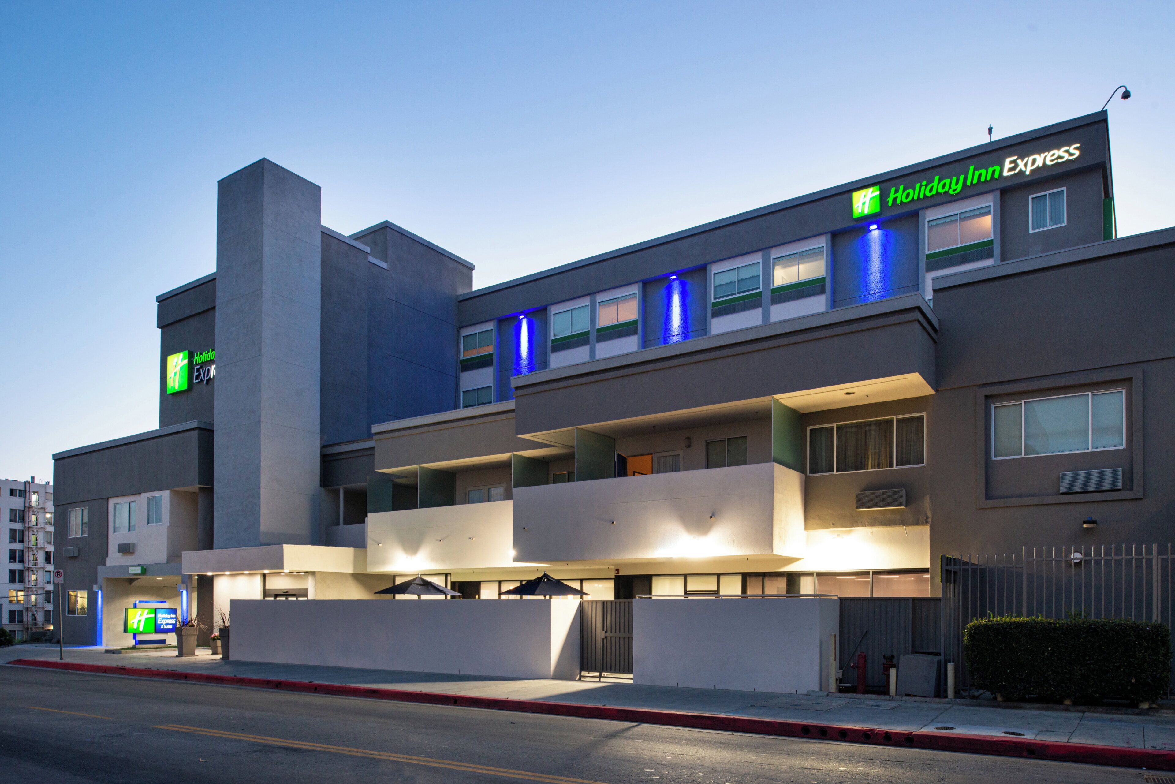 A Holiday Inn Express hotel with a modern design, featuring a flat roof, multiple windows, and a prominent entrance.