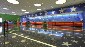 A lobby with a star-themed wall, a reception desk, and a polished floor. - Disney's All Star Sports Resort (Lake Buena Vista)