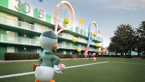 A cartoon duck character holding a tennis racket and a ball in front of a hotel with balconies and a sign reading "30 15 ALL". - Disney's All Star Sports Resort (Lake Buena Vista)