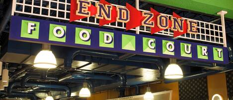 A food court with a sign reading "END ZONE FOOD COURT" and a "BEVERAGES" sign below.