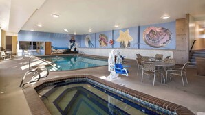 An indoor swimming pool with a diving board, lounge chairs, and a mural on the wall. - Best Western Holiday Hotel (Coos Bay)