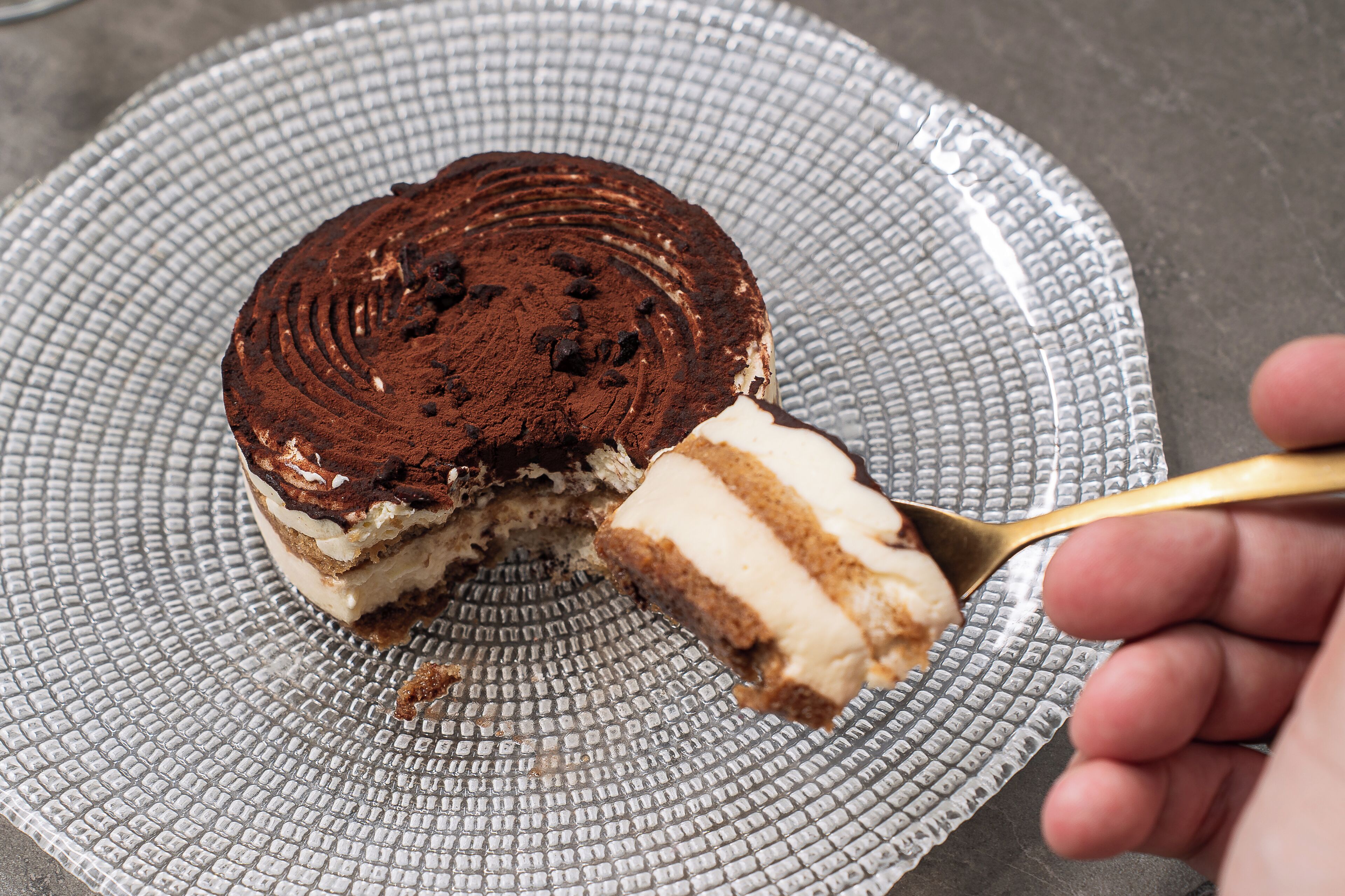 A slice of layered dessert on a textured plate.