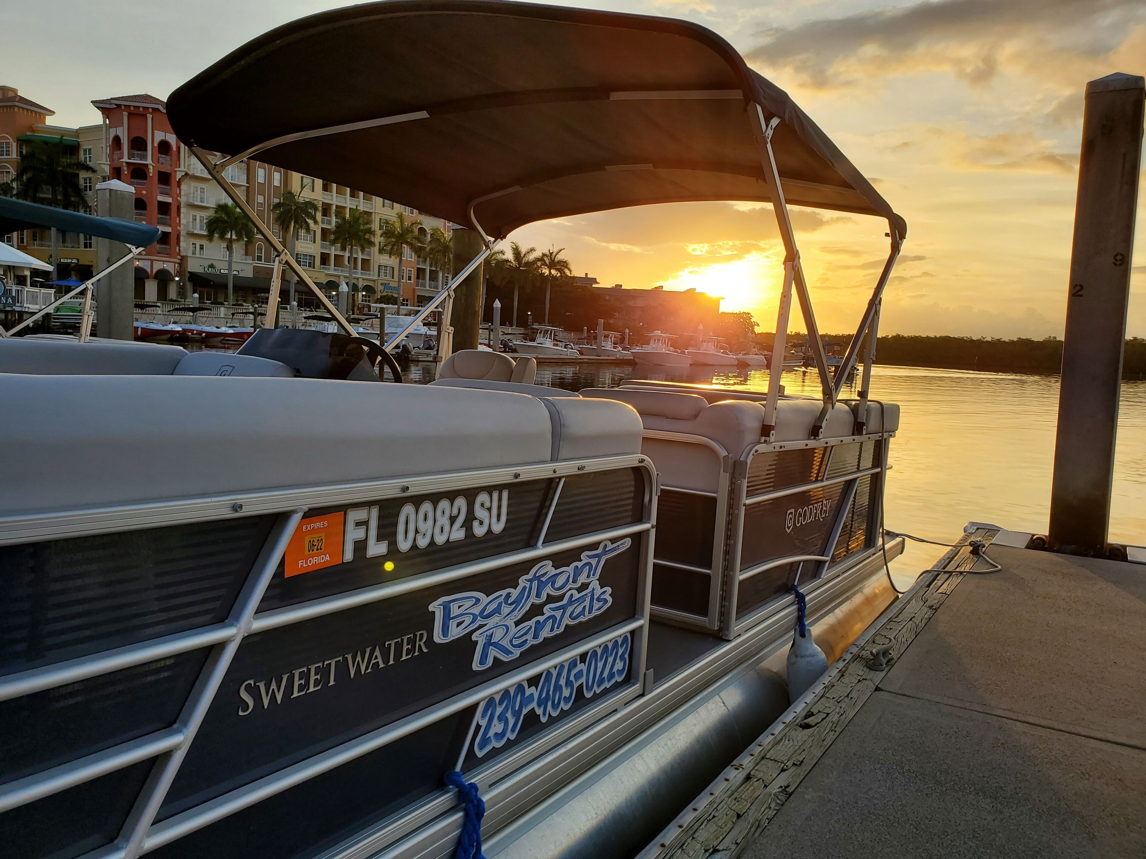 A boat with a registration plate reading "FL 0982 SU" and a rental company name "Bayfront Rentals" on the side.