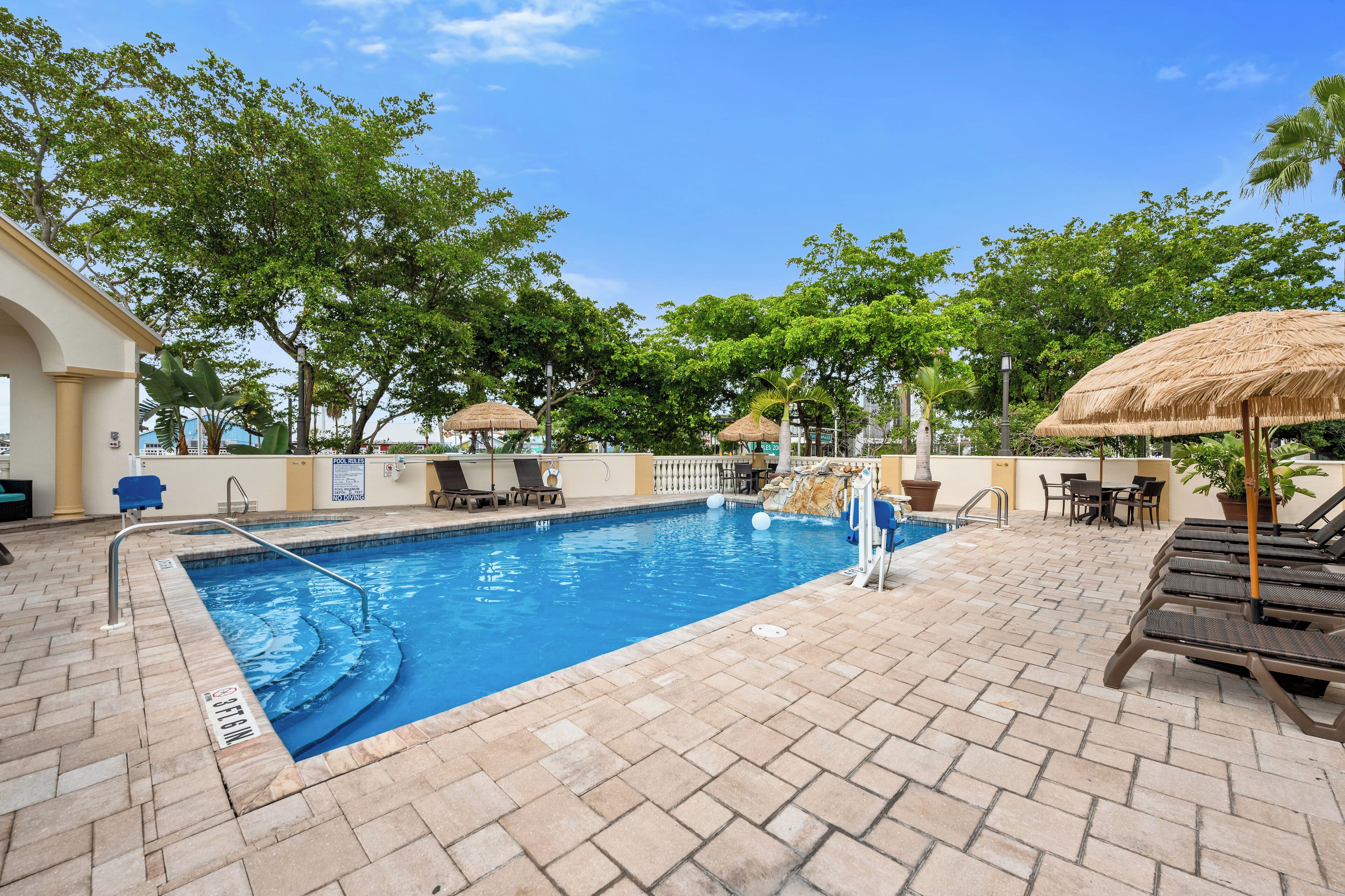 outdoor pool, open 7:00 am to 8:00 pm, pool umbrellas, pool loungers