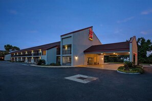 A motel with a large parking lot, a covered entrance, and a sign reading "Red Roof Plus". - Red Roof Inn PLUS+ Mt Pleasant - Patriots Point (Mount Pleasant)
