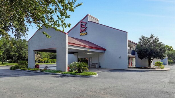 A Red Roof Plus hotel with a single-story structure, a covered entrance, and a parking lot. - Red Roof Inn PLUS+ Mt Pleasant - Patriots Point (Mount Pleasant)