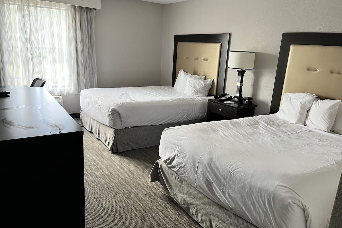 classic double room, 2 queen beds, non smoking | in-room safe, individually decorated, individually furnished, desk