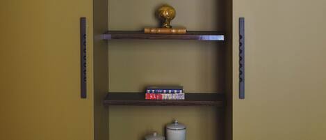A vertical shelving unit with various decorative items.