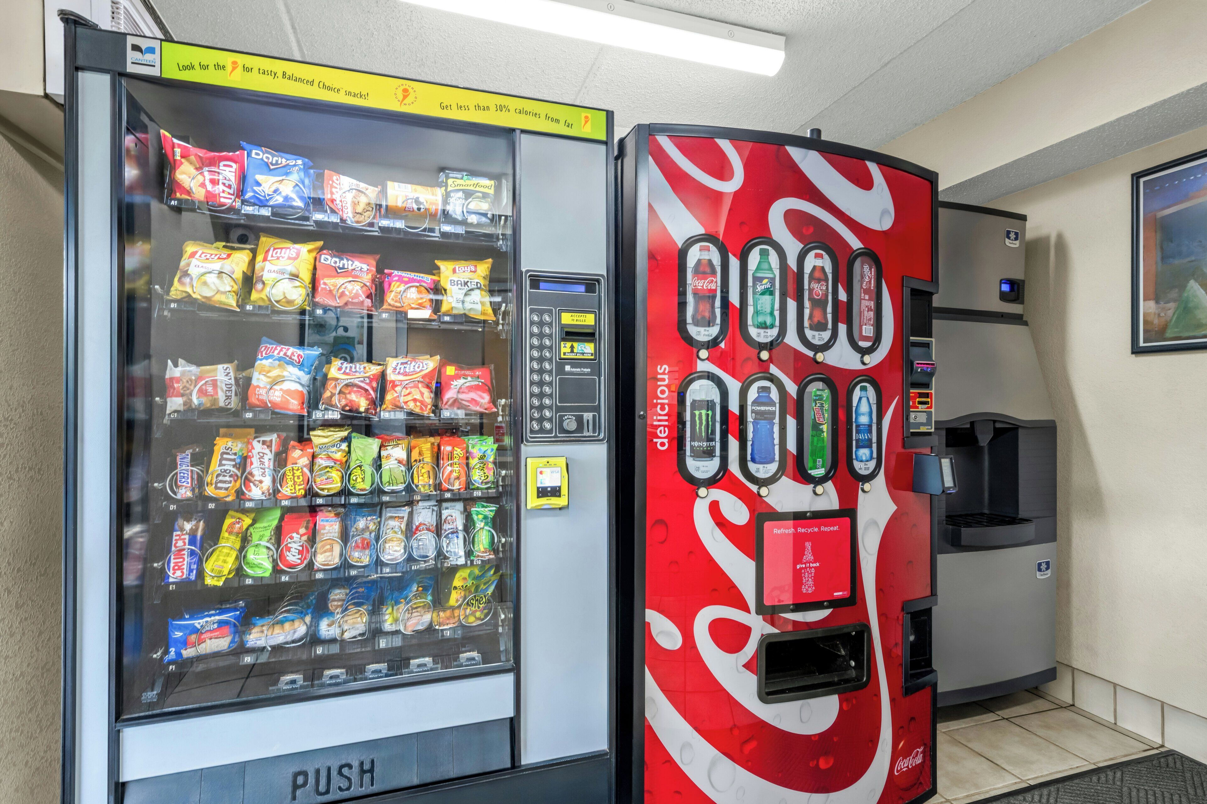 A vending machine with snacks and a Coca-Cola dispenser.
