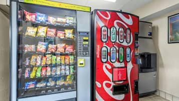 A vending machine with snacks and a Coca-Cola dispenser.