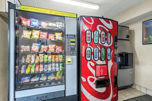 A vending machine with snacks and a Coca-Cola dispenser. - Red Roof Inn Asheville - Biltmore West (Asheville)