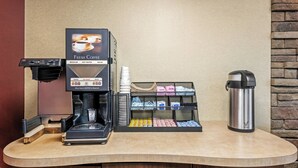 A coffee machine with a coffee cup holder, a beverage dispenser, and a thermos on a counter. - Red Roof Inn Asheville - Biltmore West (Asheville)