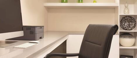 A modern office desk with a computer, keyboard, and mouse.