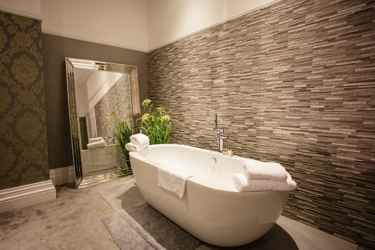 deluxe room, multiple beds, non smoking | deep-soaking bathtub