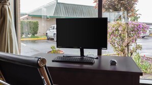 A desk with a computer monitor, keyboard, and mouse. - Days Inn by Wyndham Auburn (Auburn)