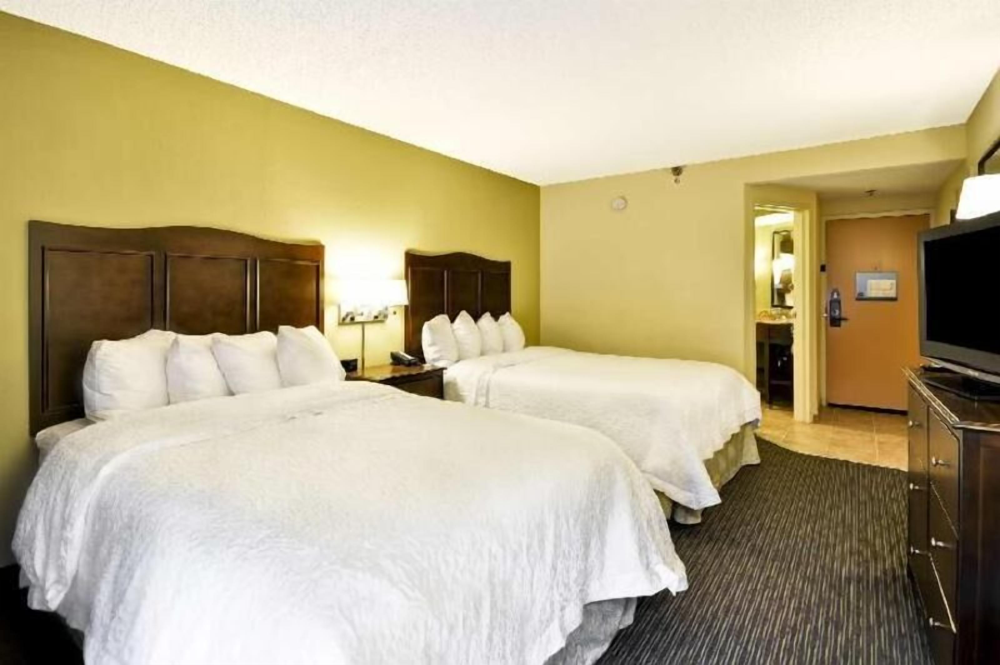 Hypo-allergenic bedding, desk, laptop workspace, blackout drapes