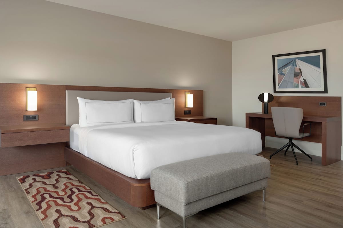 Premium bedding, desk, laptop workspace, iron/ironing board