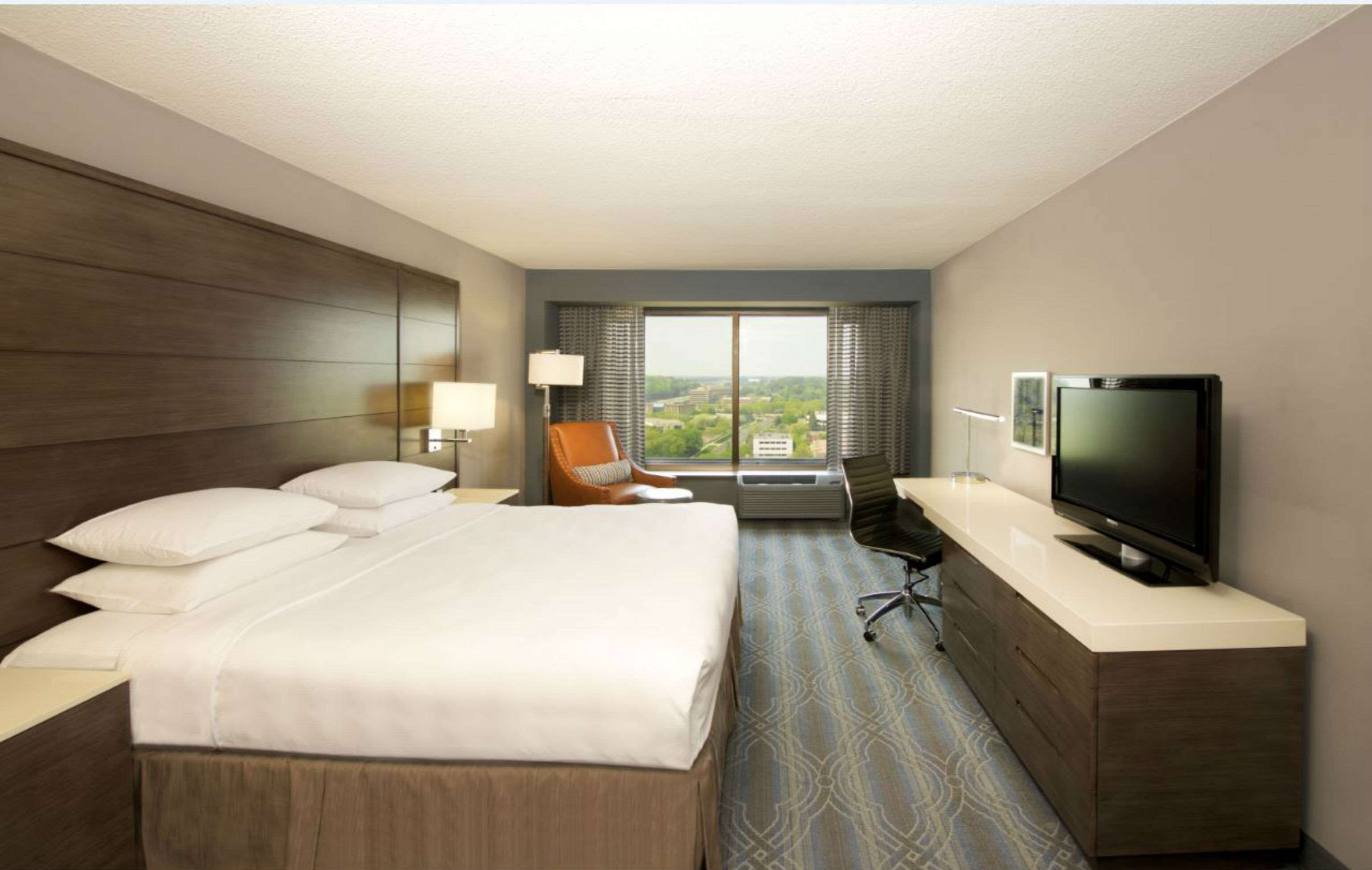 Premium bedding, desk, laptop workspace, iron/ironing board