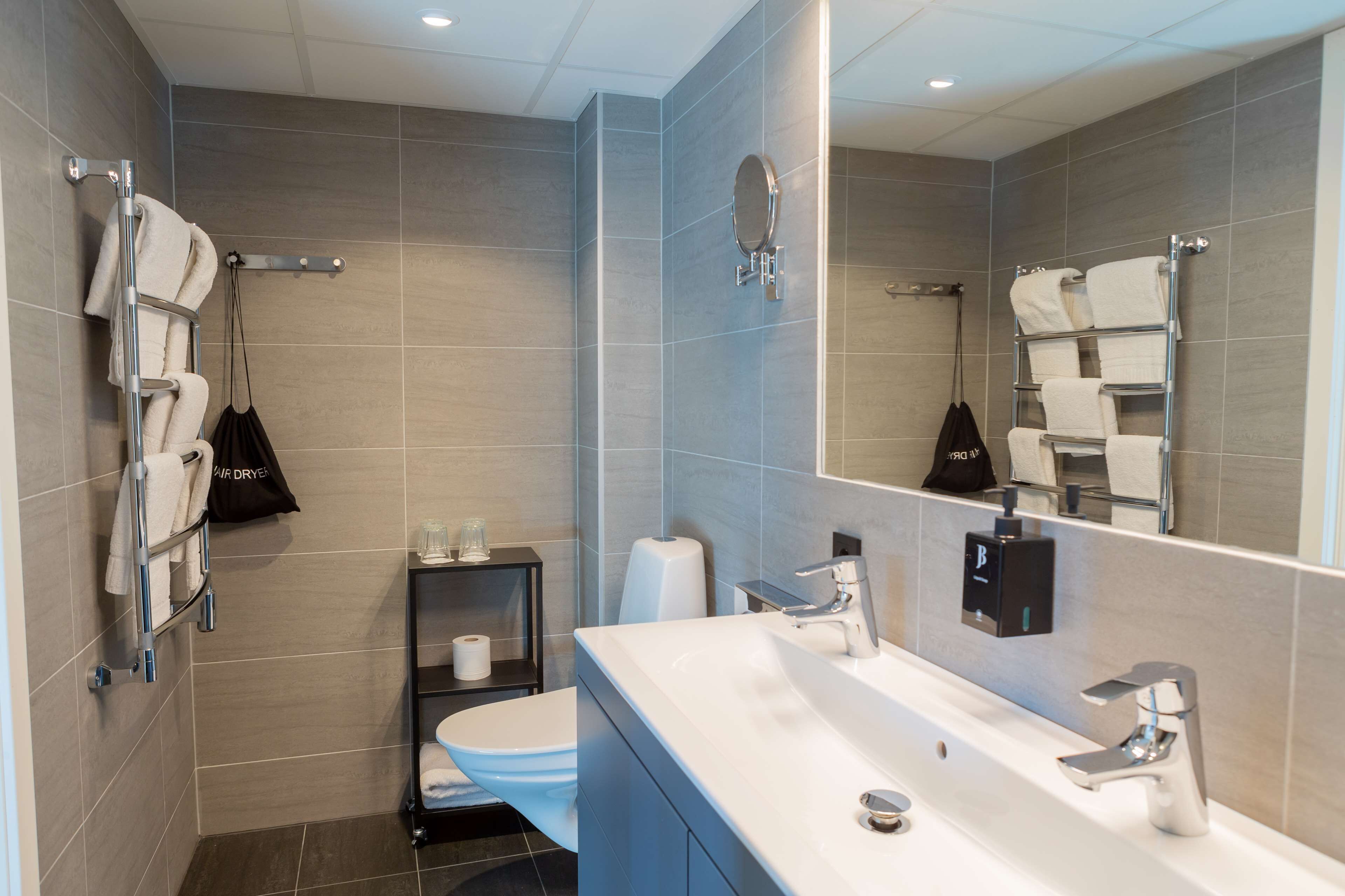 family suite, multiple beds, non smoking (living room;with sofabed) | bathroom | hair dryer, heated floors, towels