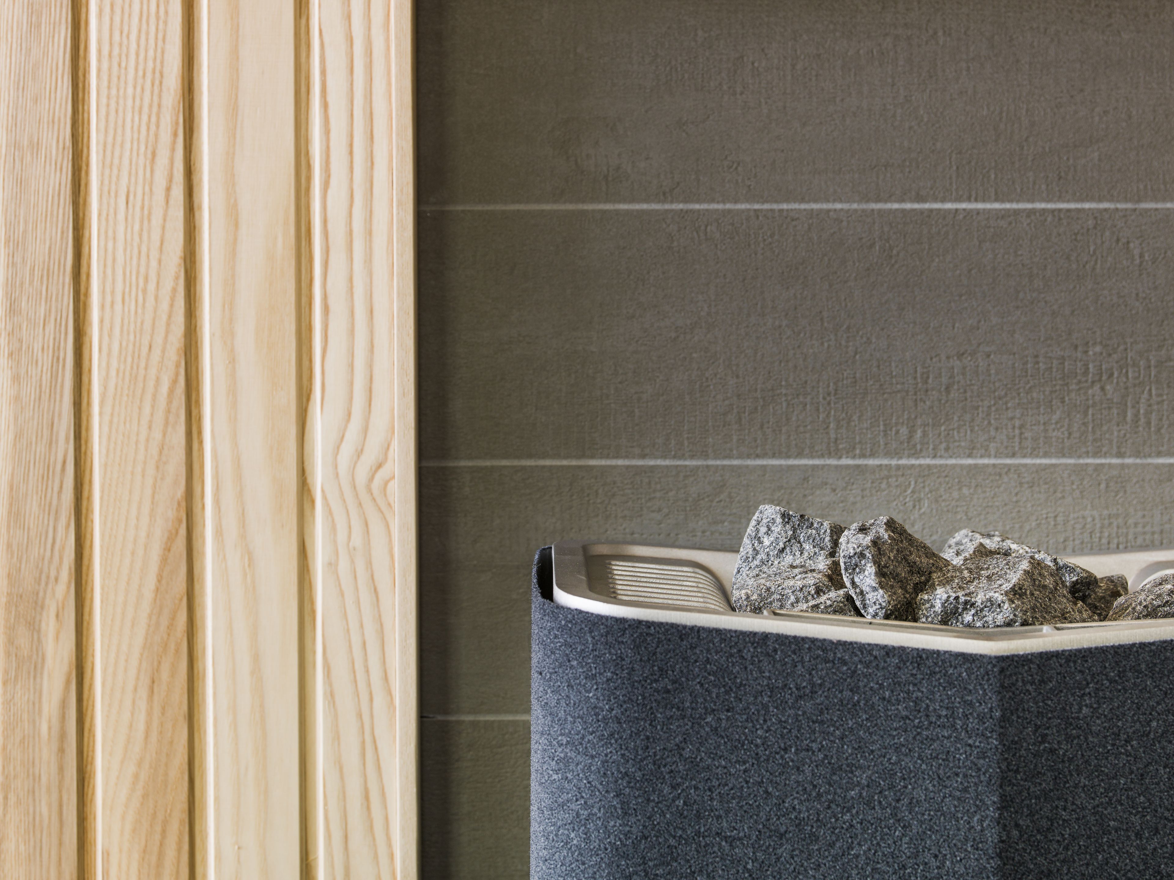A bathroom with a wooden vanity and a grey sink.