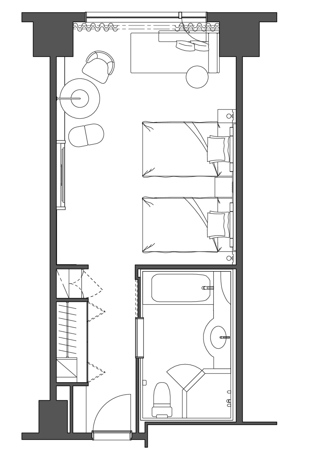 A floor plan of a hotel room with a bed, a desk, a chair, a small table, including a lamp, a sofa, and a TV.