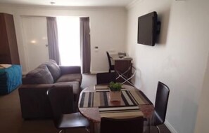 Studio, 1 Bedroom | Living area | 40-inch flat-screen TV with digital channels, TV
