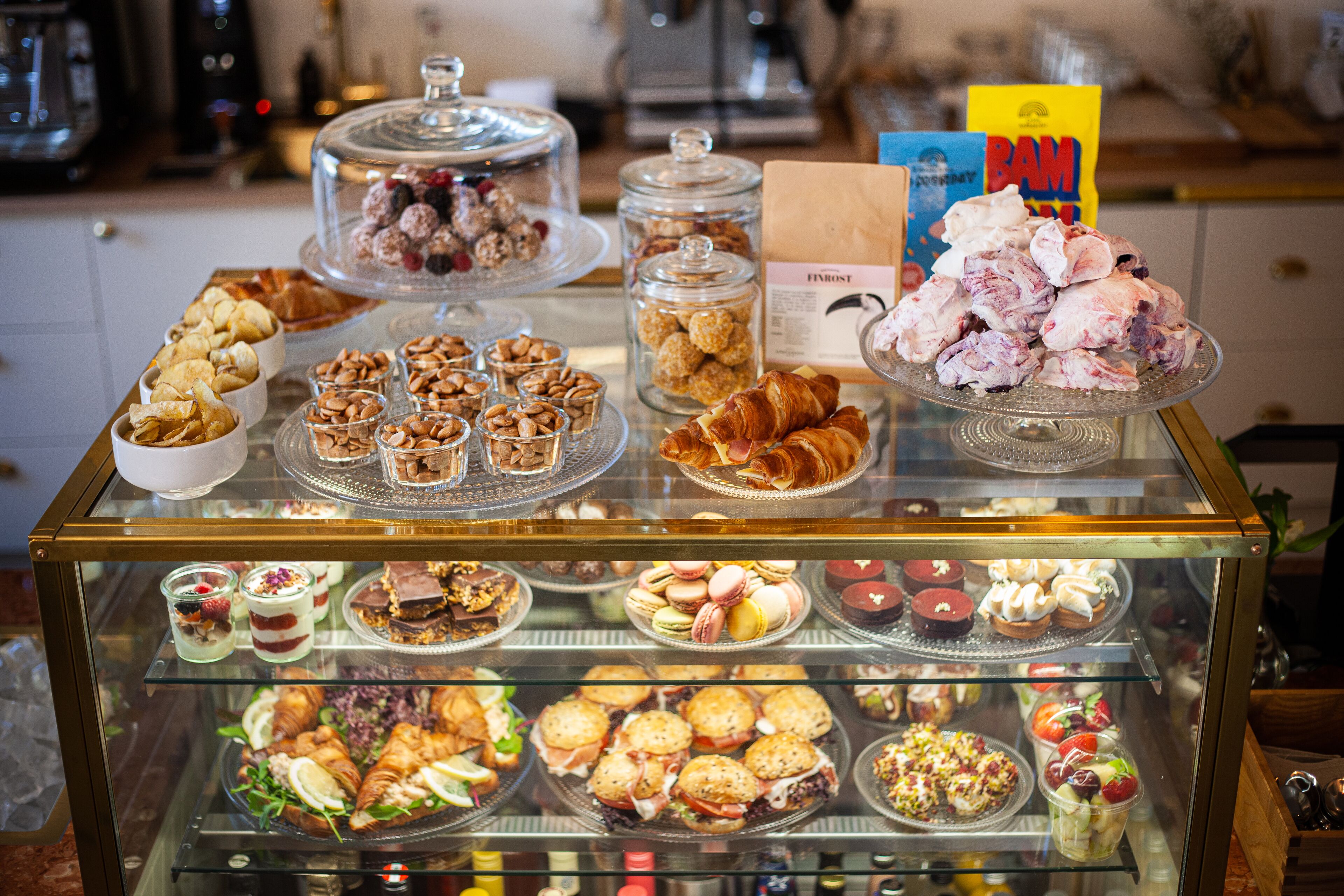 A display case filled with various pastries and desserts.