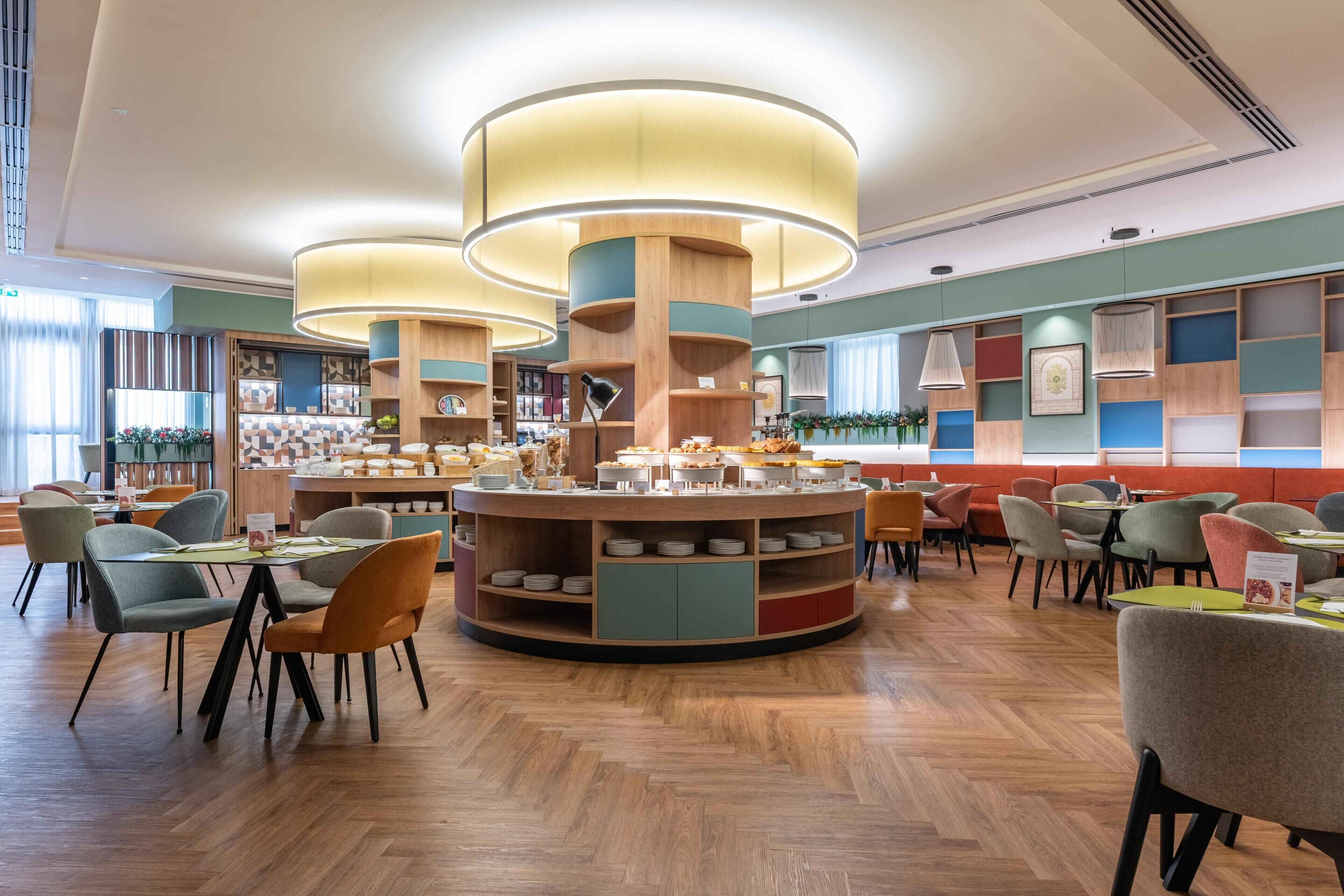 A modern dining area with a central buffet and multiple seating arrangements.
