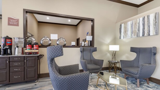 A hotel lobby with seating, a coffee station, and a large mirror. - Best Western near Lackland AFB/SeaWorld (San Antonio)
