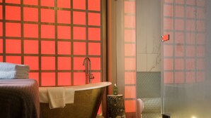 A modern bathroom with a freestanding bathtub, a glass shower enclosure, and a wooden stool. - Bishopstrow Hotel & Spa (Warminster)