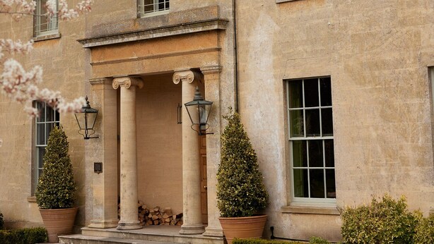 A historic building with a symmetrical facade, large windows, and a central entrance with columns. - Bishopstrow Hotel & Spa (Warminster)