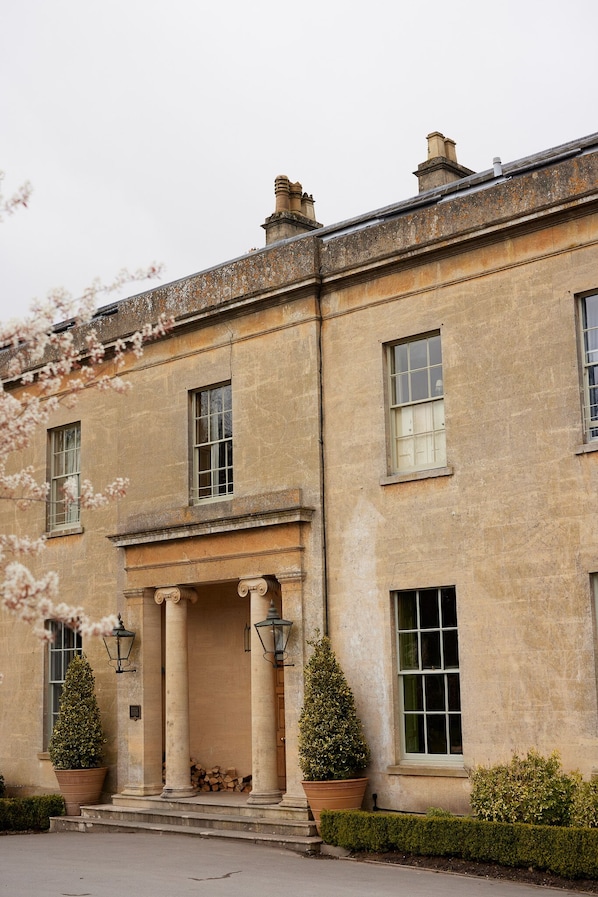 A historic building with a symmetrical facade, large windows, and a central entrance with columns. - Bishopstrow Hotel & Spa (Warminster)