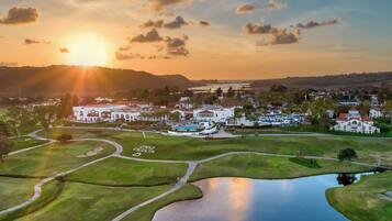 Enjoy a serene golf experience surrounded by lush greenery and a tranquil lake.
