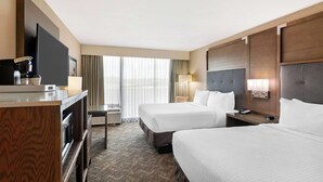 A hotel room with two beds, a TV, a coffee machine, and a desk. - Best Western Plus Kansas City Sports Complex Hotel (Kansas City)
