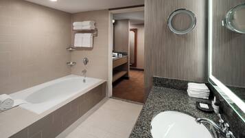 A modern bathroom with a bathtub, a sink, and a shower area.