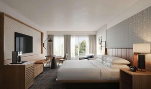 Une chambre d’hôtel moderne équipée d’un grand lit, d’un bureau, d’une chaise, d’une télévision et d’une fenêtre avec des rideaux.