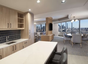 A modern kitchen with wooden cabinets, a marble countertop, and a city view through large windows.