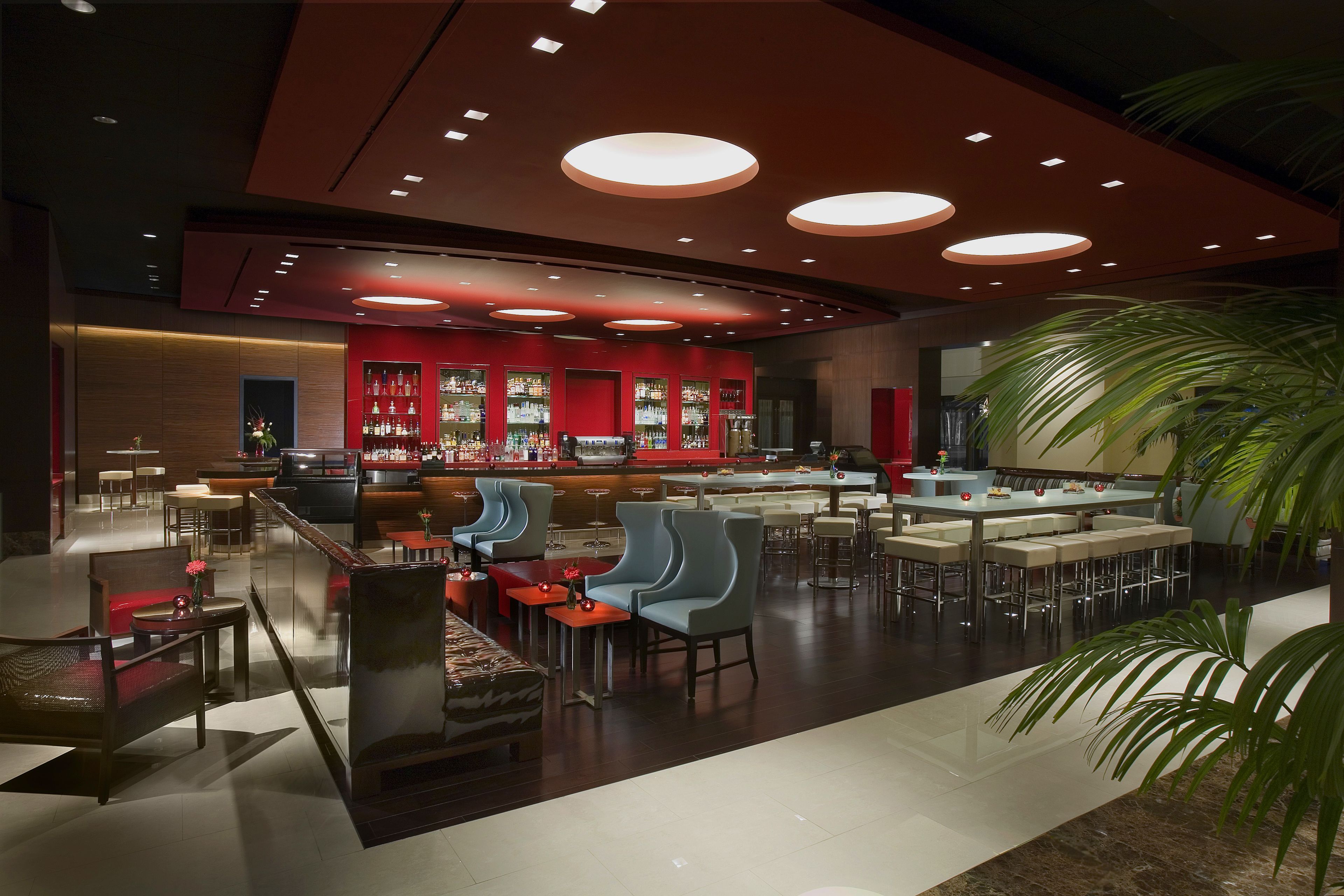 A modern bar area with seating and a bar counter.