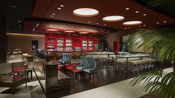 A modern bar area with seating and a bar counter.