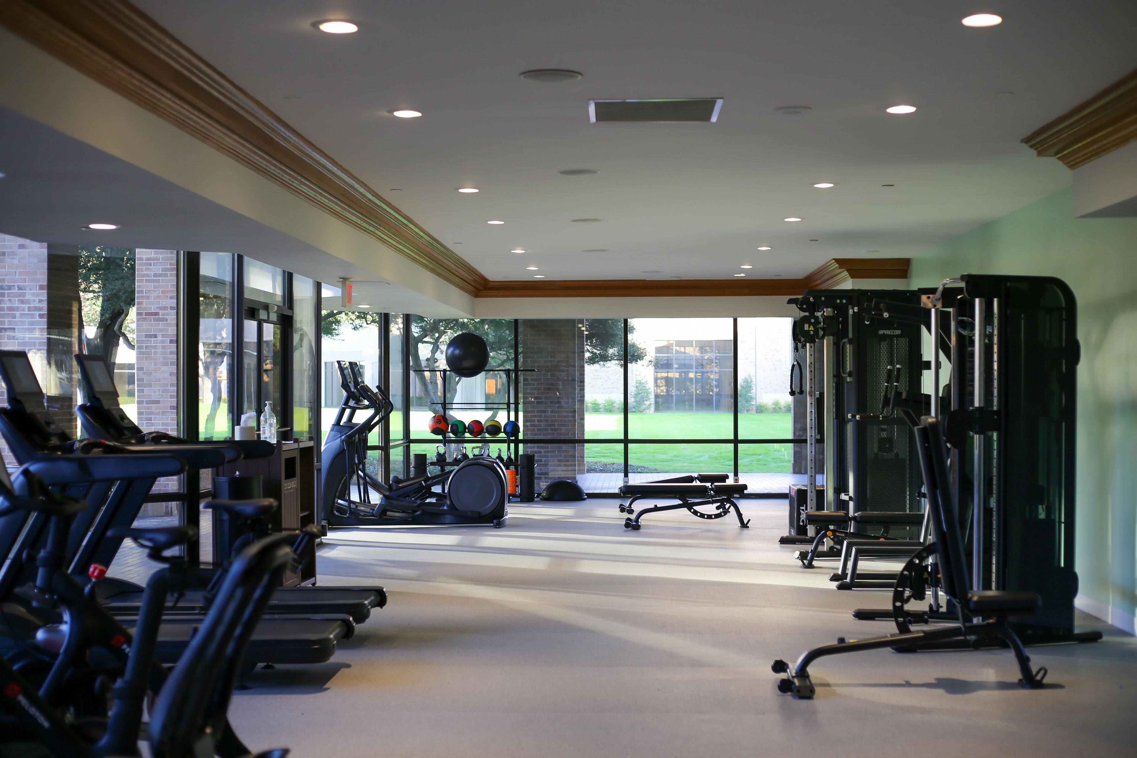 A gym with treadmills, exercise balls, and weight machines.
