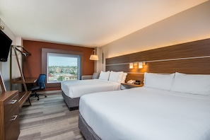 A hotel room with two beds, a desk, a chair, a TV, and a window with a city view. - HI Express El Paso Downtown by IHG (El Paso)