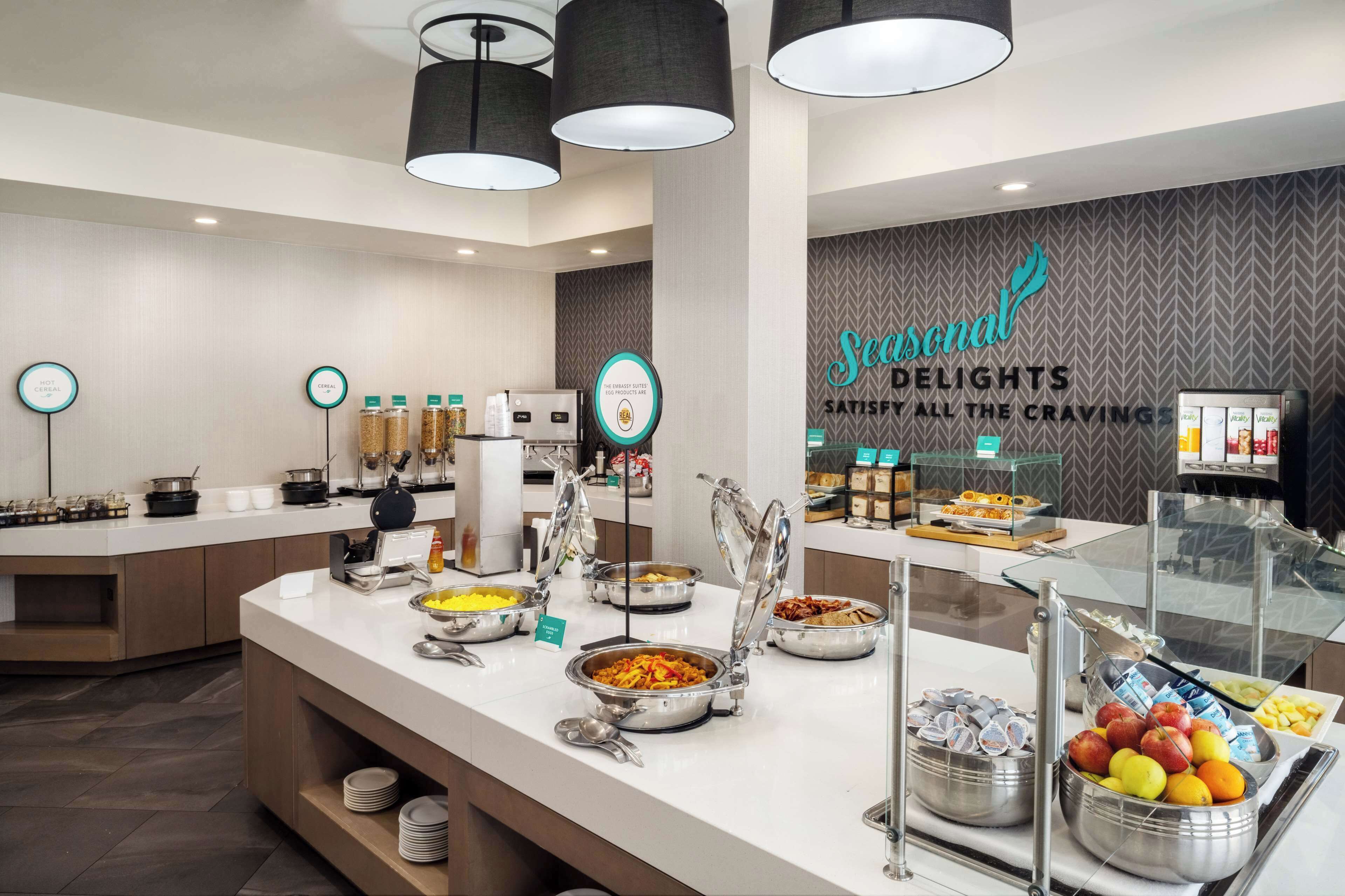A buffet area with various food options and a sign that reads "Personal Delights Satisfy All the Cravings".
