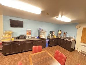 Enjoy cooking and dining in this fully equipped kitchen with a long counter and dining table.