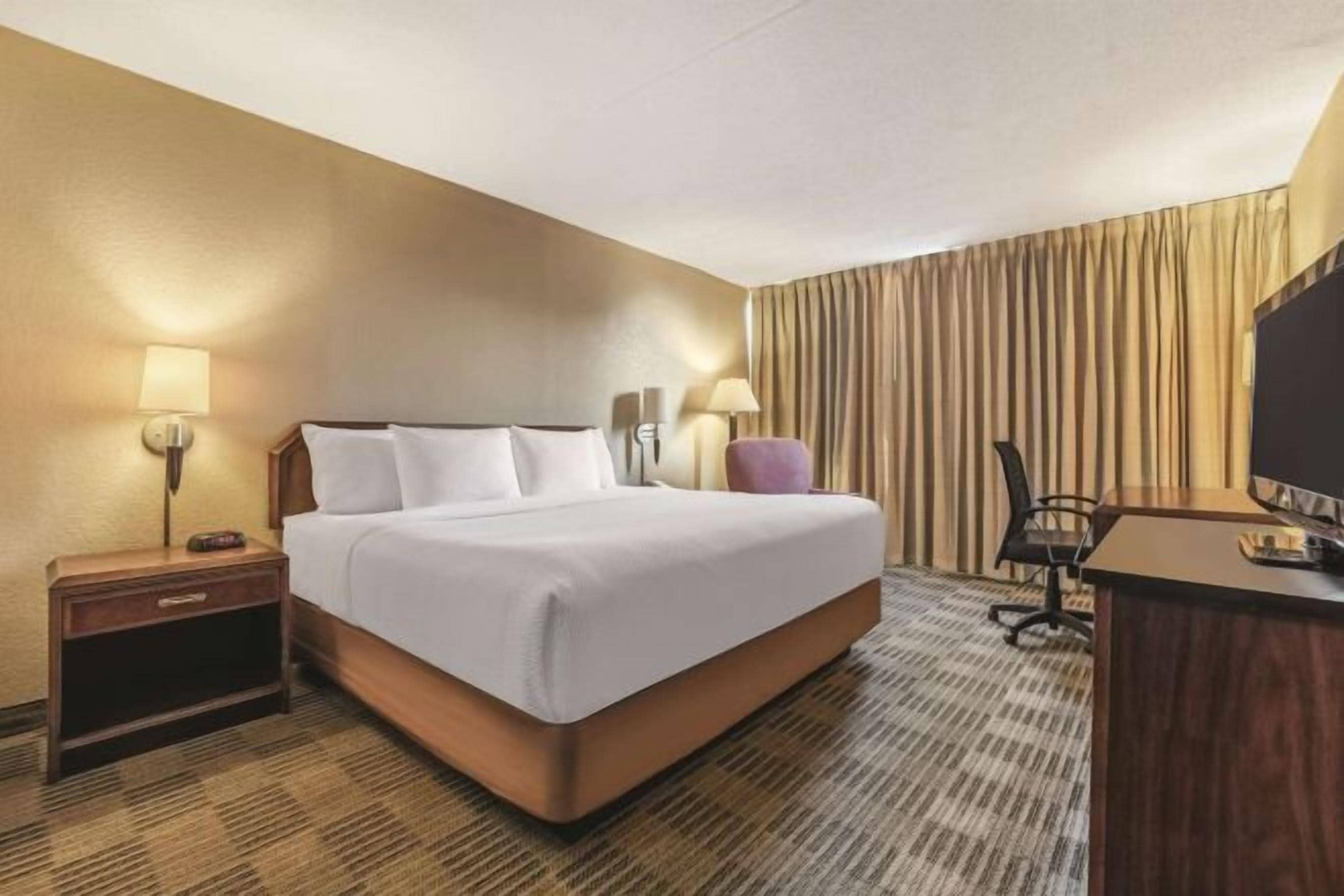 Premium bedding, desk, laptop workspace, iron/ironing board