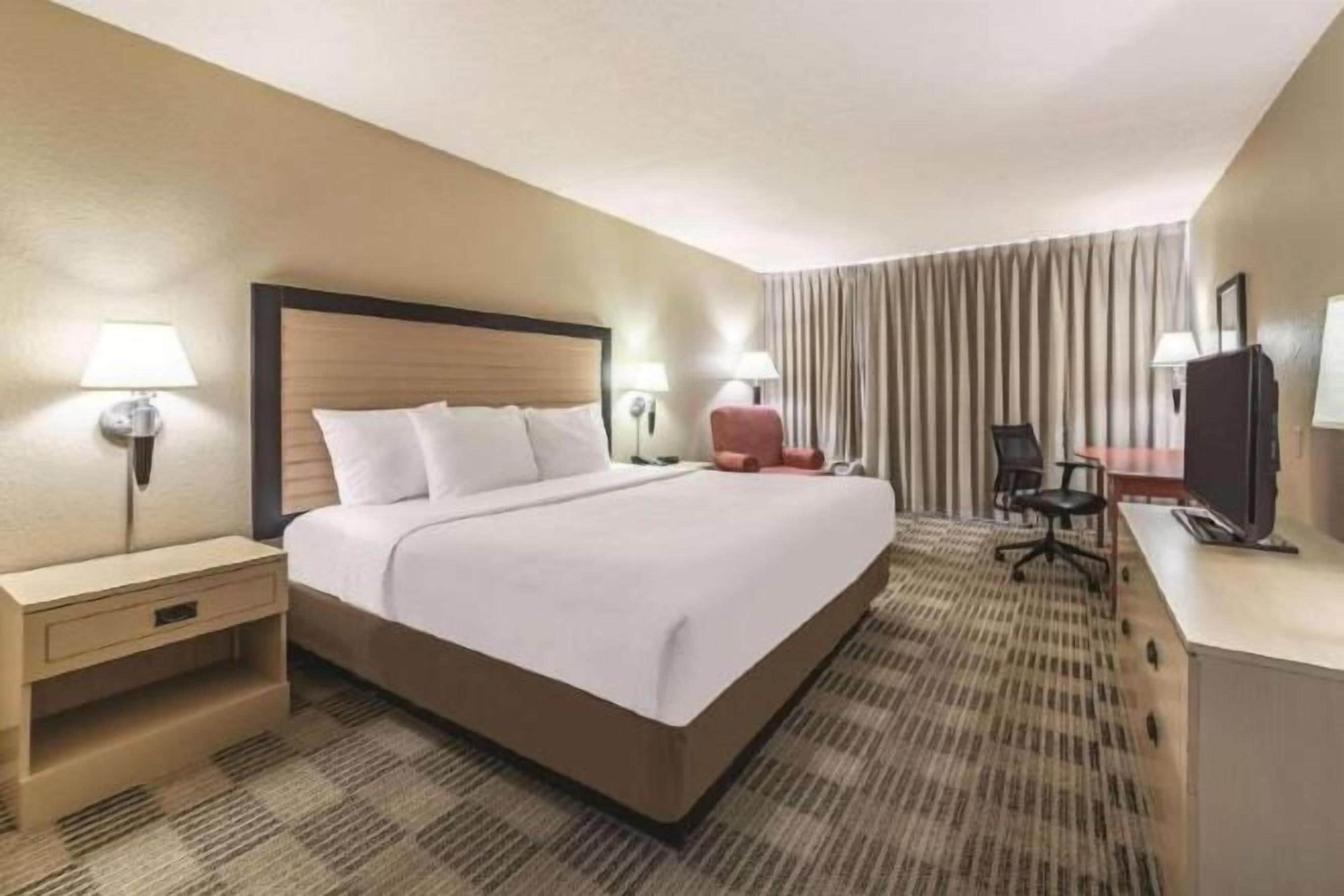 Premium bedding, desk, laptop workspace, iron/ironing board