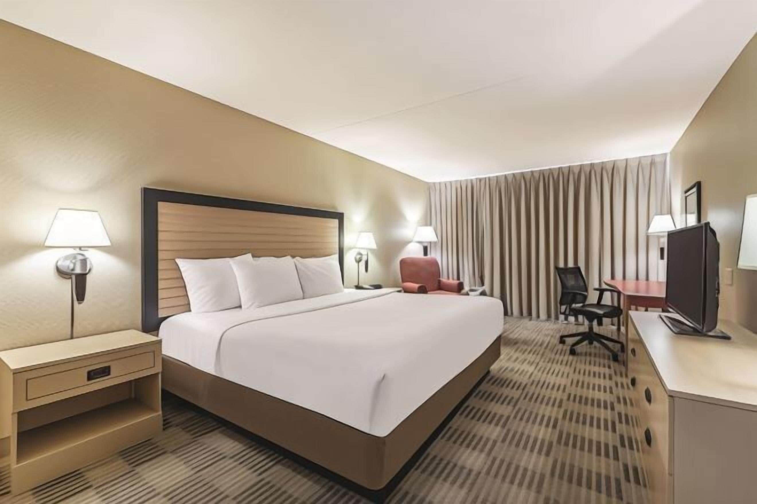 Premium bedding, desk, laptop workspace, iron/ironing board