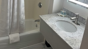 A bathroom with a shower, toilet, and sink. - Howard Johnson by Wyndham Malden Boston Area (Malden)
