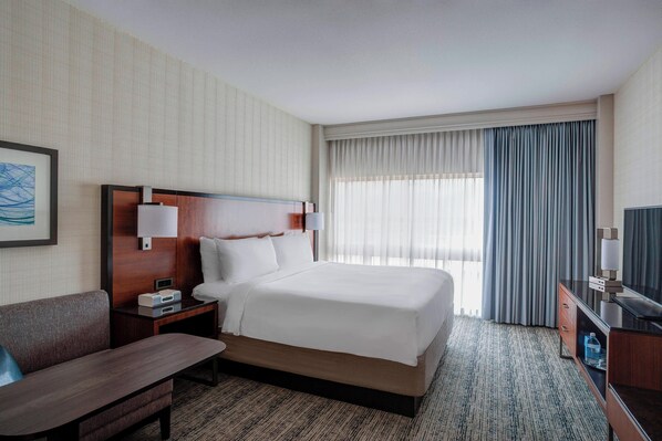 Relax in comfort with a large bed, flat-screen TV, and cozy seating area.